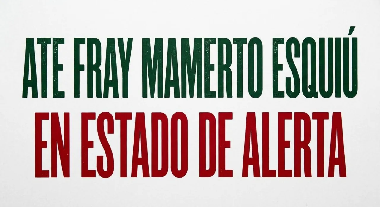 Texto sobre fondo blanco que dice "ATE FRAY MAMERTO ESQUIU EN ESTADO DE ALERTA" en letras verdes y rojas.