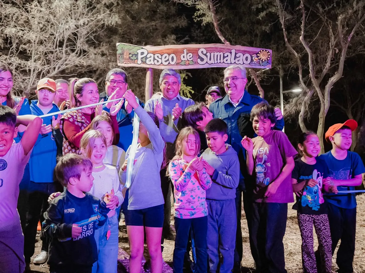 Raúl Jalil y varias personas cortan una cinta inaugural frente a un cartel de madera que dice Paseo de Sumalao.