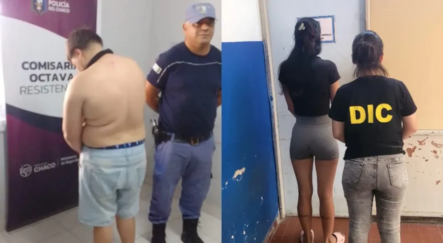 Un hombre y una mujer de espaldas son escoltados por dos efectivos policiales junto a una pared.