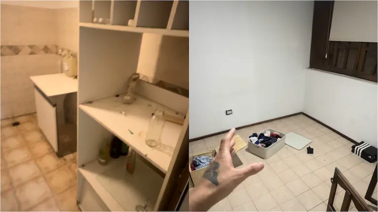 Una mano en primer plano señala hacia una habitación desordenada con ropa en el suelo junto a un mueble blanco.
