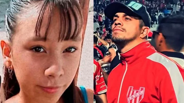 Retrato de una chica al lado de un joven con campera deportiva roja del club Instituto y gorra negra.