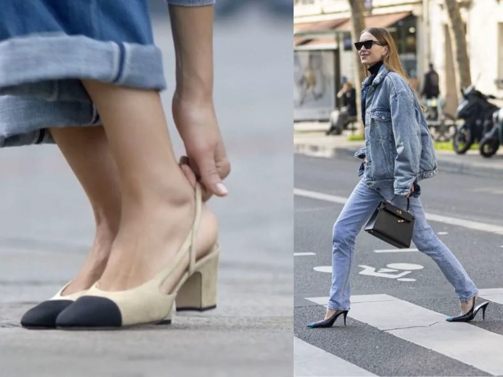 Una mujer con campera de jean cruza la calle mientras en primer plano otra se acomoda un zapato beige con taco.