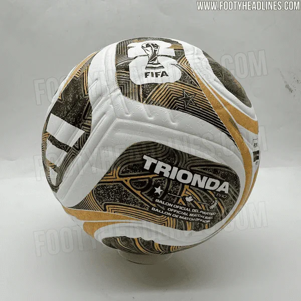 Pelota de futbol blanca con vivos dorados y negros que lleva la inscripcion Trionda.